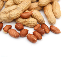 Dried peanuts in closeup on white