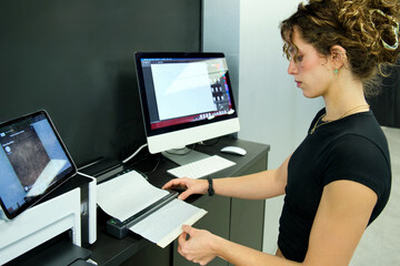 Tattoo artist preparing stencil for client