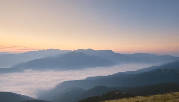 peaceful blue nature background with foggy bucegi mountains in carpathians seen from cota 2000 sinaia resort romania