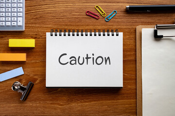 There is notebook with the word Caution. It is as an eye-catching image.
