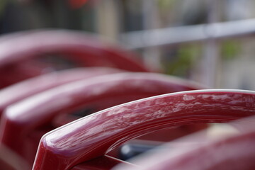 Macro of row of shiny red bus seats, blurred background