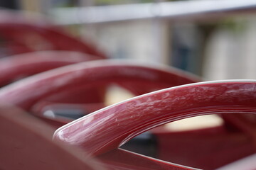 Macro of row of shiny red bus seats, blurred background