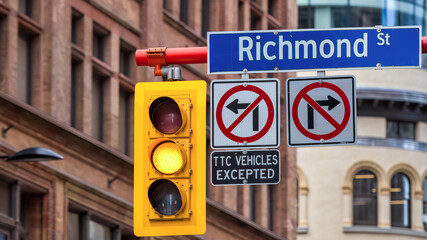 Street sign and stop light in downtown Toronto, Canada - obrazy, fototapety, plakaty