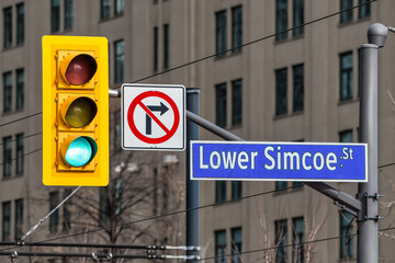 Fototapeta premium Street sign and stop light in downtown Toronto, Canada