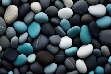 Fototapeta na wymiar Beach pebbles. Blue, green and turquoise toned stones. Beautiful nature background image on black. Layer of pretty aesthetic rocks. Creativity with natural objects. Creative art design project idea