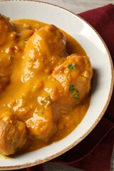 Tasty fresh chicken curry on wooden table