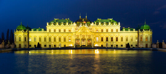 Famous Schloss Belvedere reflected in water at night in Vienna, Austria