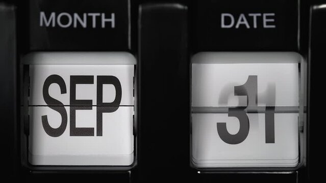 retro flip calendar with a date change from the thirtieth of September to the first of October. daily calendar with a change of days of the month. close up.