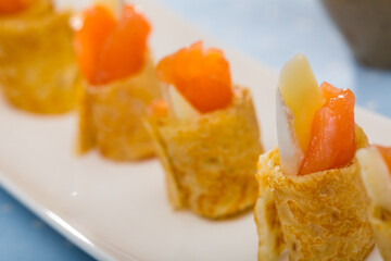 Pancakes rolls with salted salmon on a plate. High quality photo