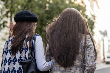 Asian young female friends walking on the street in the city