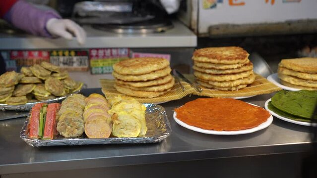 Korean market gwangjang market munk bean pancakes and fried stuffs sausage Korea street food