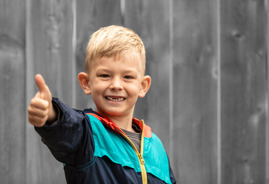 boy showing thumb up sign