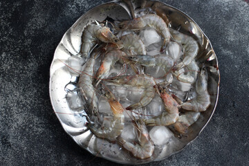 Raw Shrimps on ice cube. Top View. 