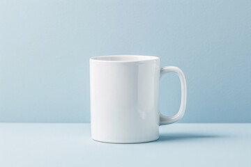 A lone white ceramic coffee cup sits empty on a wooden table - obrazy, fototapety, plakaty
