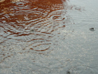 Photo of rainwater from pipes and floors on the top floor of an urban building