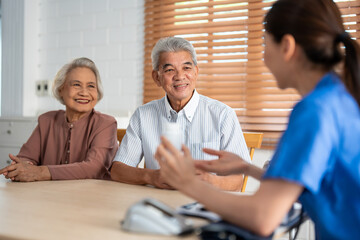 Asian caregiver nurse examine senior man and woman patient at home. 