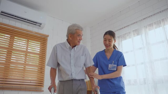 Asian senior elderly man patient doing physical therapy with caregiver. 