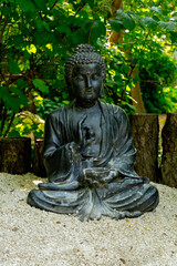 Japanese garden. Decorative garden sculpture of Buddha.
