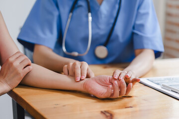 Healthcare professional taking a patient's pulse, emphasizing personal care and attention in a...