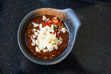 Dipping sauce with white sesame topping with chopped fresh chilli and minced garlic.  Sukiyaki sauce