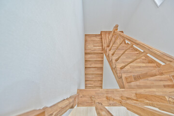 Bright wooden colored stairs that match a neat design interior
