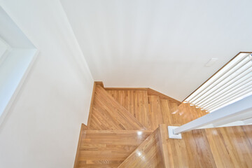 Stunning bright wooden color staircase made of maple wood with interior design