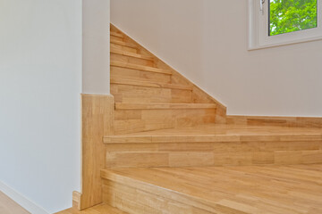 Stylish and pretty bright-colored wooden colored stairs that do not spoil the interior of your home