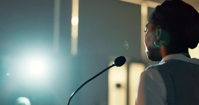 Woman, speaker and audience presentation or seminar talking for business start up, conference or convention. Black person, microphone and international tradeshow with spotlight, event or training