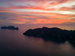 A stunning sunset over a small Phi Phi islands surrounded by sea and clouds