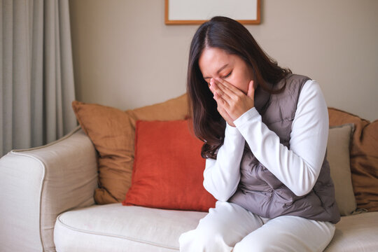 Portrait image of a woman get sick and sneezing