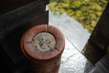 Decorative stone ashtray with cigarette butts, close-up.