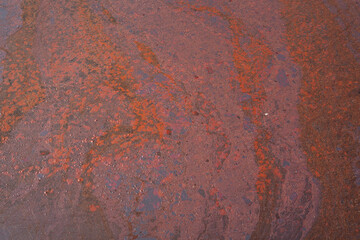 Dirty crude oil is splash on liquid surface due to oil spill to the environment accident. Background and texture, close-up and selective focus.	
