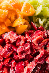 frozen chopped up bell peppers in red green and yellow varieties in glass container,