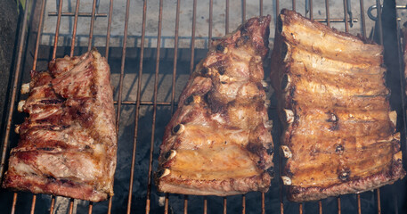Roasted Juicy spare ribs cooked over the coals on a barbecue. Summer and holiday time. Delicious food