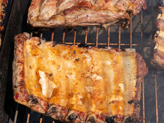 Roasted Juicy spare ribs cooked over the coals on a barbecue. Summer and holiday time. Delicious food