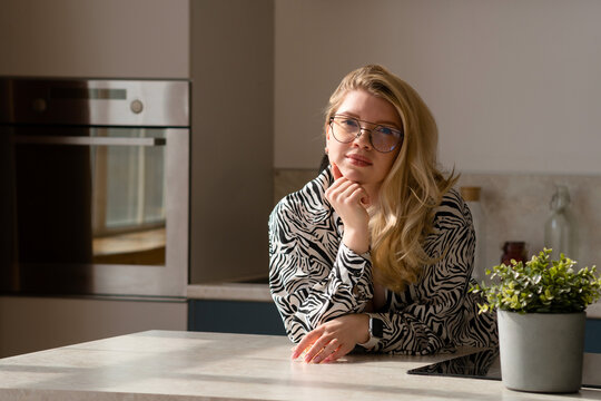 Contemplative woman at kitchen table