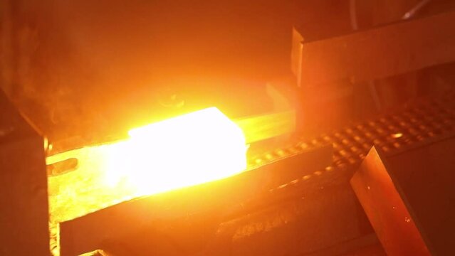 blast furnace metal block heating process in foundry on a conveyor belt in billet heater with pyrometer for closed die hammer forging in a forged part manufacturing production iron steel alloy factory