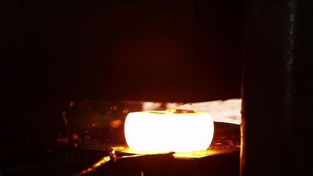 forging concept drop forging metal piece shaping automatic drop hammer a tool shape. Open die forging hit by hammer on a tool mould cast to form a machine component part isothermal weld factory