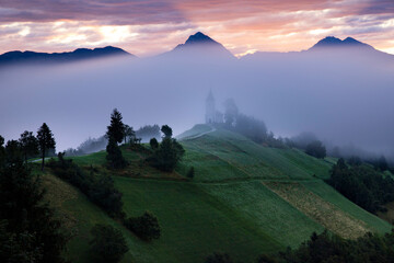 Jamnik, Slovenia - Magical foggy summer sunrise at Jamnik St.Primoz church.