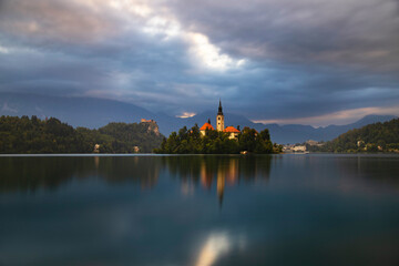 Fototapeta na wymiar Amazing View On Bled Lake, Island,Church And Castle With Mountain Range