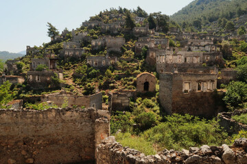 Ruins of houses on a hill in the abandoned village of Kayaköy, Livissi, close to Fethiye, Turkey
