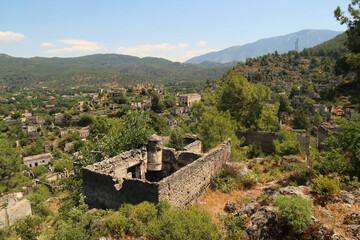 View on the abandoned village of Kayaköy, Livissi with a traditional house with chimney and...