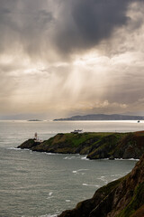 Howth Cliffs, Dublin, Ireland. Cloudy landscape with Ireland coastline, Howth Lighthouse and North Sea. Howth Cliffs Walk.