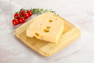 Maasdam cheese brick over board