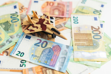 Background of one hundred dollar bills with model fighter airplane 