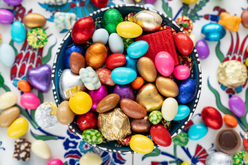 Fototapeta na wymiar Eid Celebration Among Family with Chocolate (Çikolata ile Bayramlasma) Colorful Candy and Chocolate, Ramadan Kareem Concept Photo, Üsküdar Istanbul, Turkiye (Turkey)