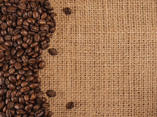 Coffee beans on linen texture background