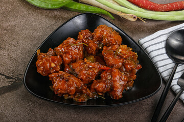 Manchurian chicken with sauce and spices