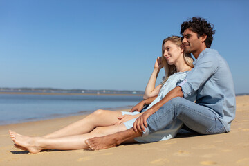 happy couple siting on beach romantic man and woman
