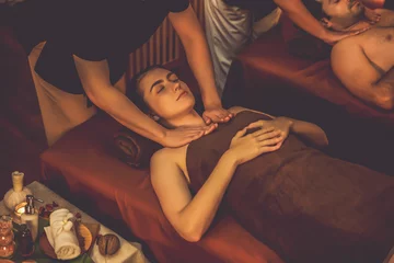 Zelfklevend Fotobehang Caucasian couple customer enjoying relaxing anti-stress spa massage and pampering with beauty skin recreation leisure in warm candle lighting ambient salon spa at luxury resort or hotel. Quiescent © Summit Art Creations